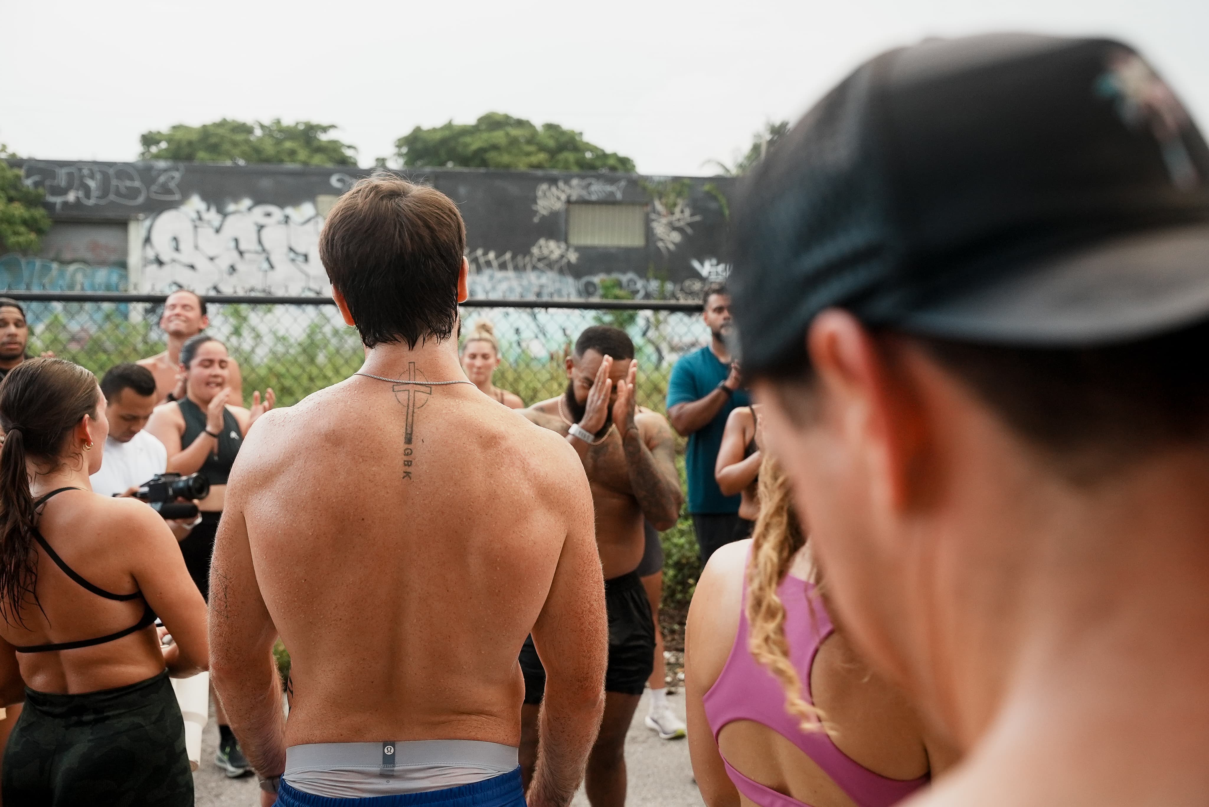 Community Sweat in a circle on outdoor asphalt — Miami, showing up